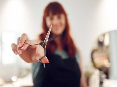 Why is it important for a beauty school to offer scholarships and:or financial aid?